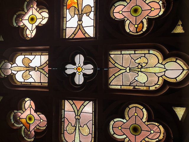 A stained-glass window glowing in afternoon light